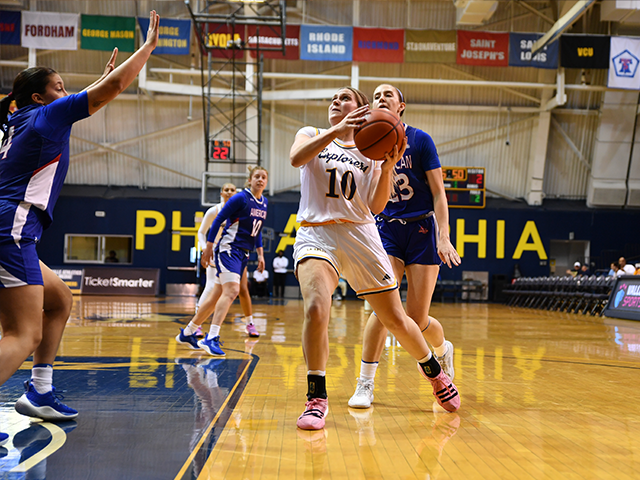 Image of a women's basketball player about to shoot the ball.