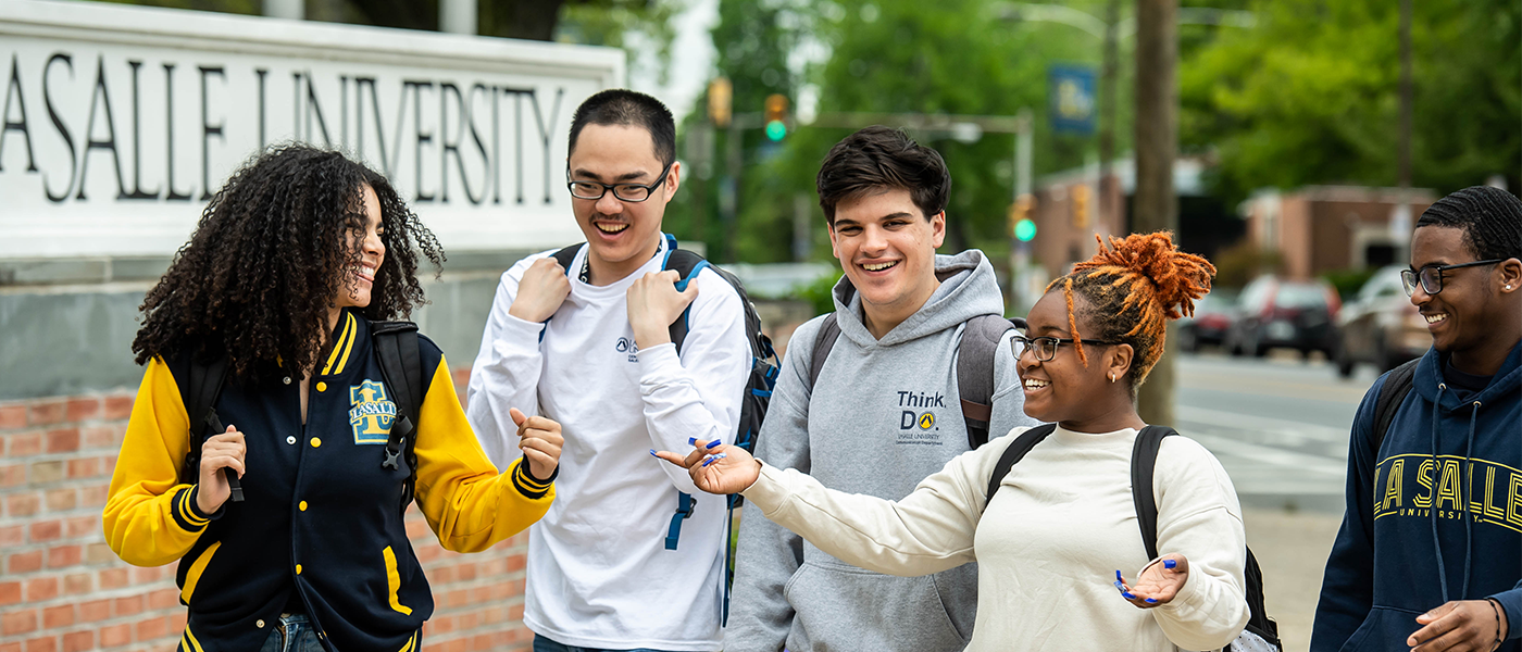 Image of a group of students walking around campus.