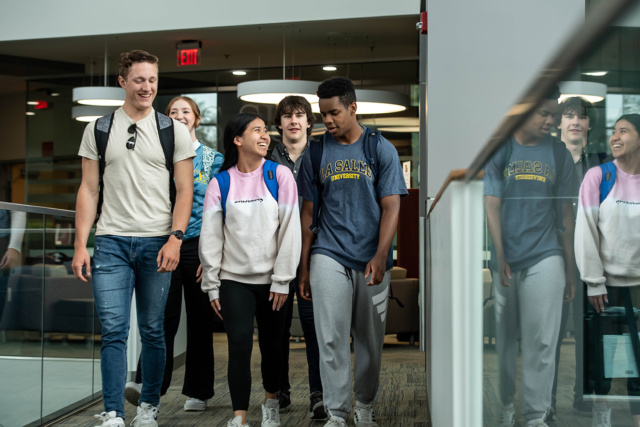 group of students walking down hallway in Founders' Hall