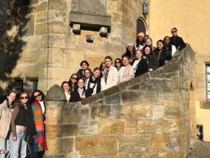 Image of students posing for photos on a staircase.