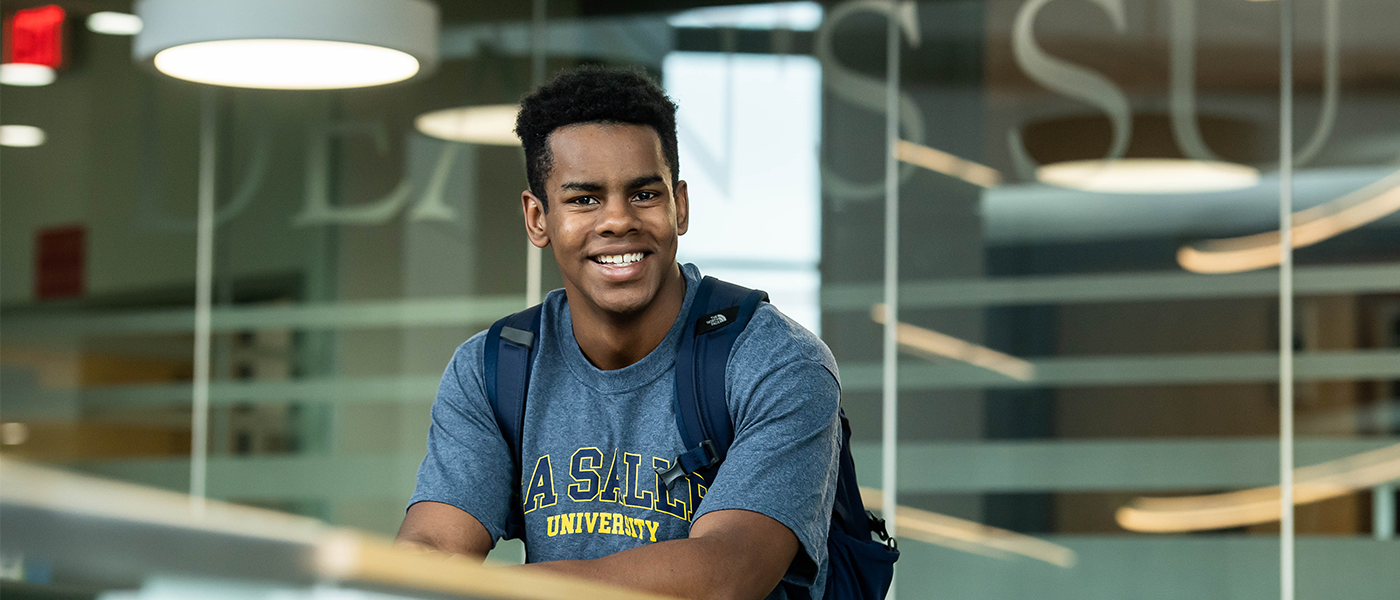 Image of a male student in an academic building.