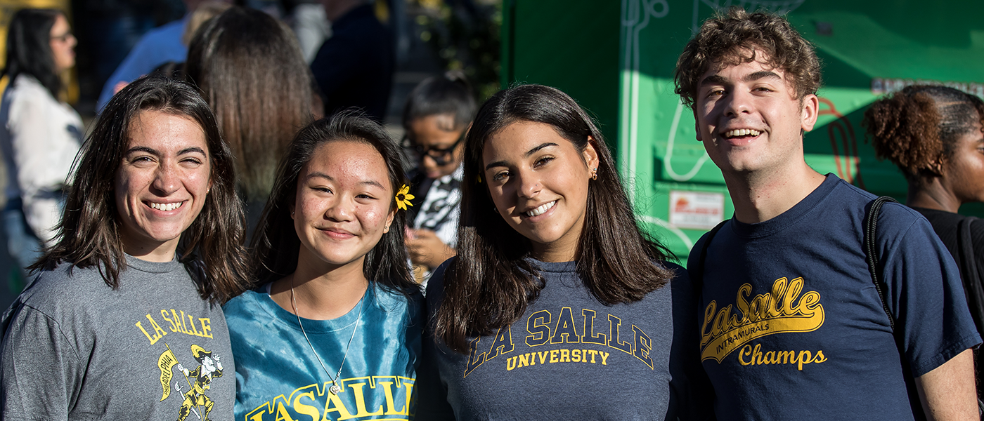 Image of four students at Homecoming.