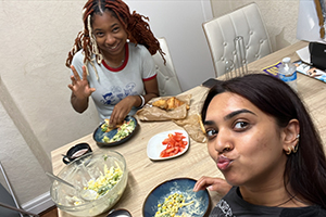 Best friends and roommates in Philadelphia, Issa Jalloh, ‘25 (top), and Kashish Patel, ‘25, share a meal at their London apartment.