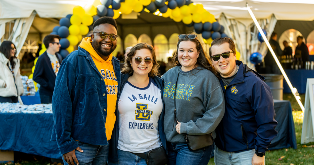 Image of 4 alumni at Homecoming