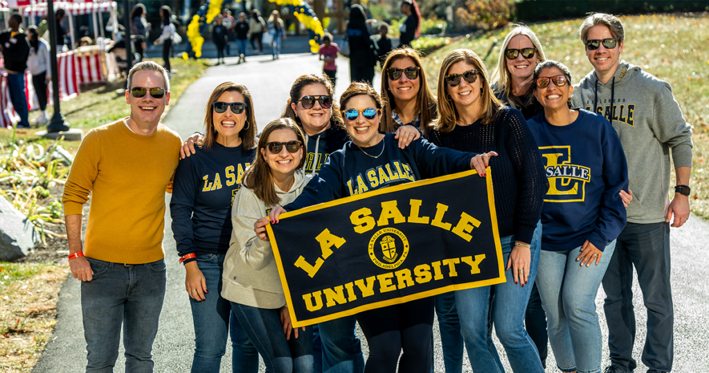 Image of alumni holding a La Salle flag