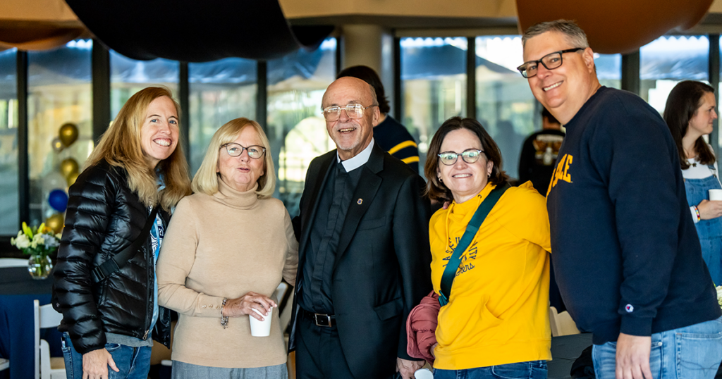 Image of alumni posing with a Christian Brother