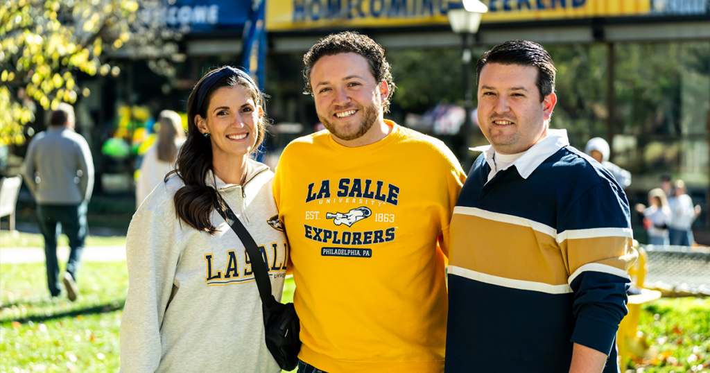 Image of three alumni at Homecoming